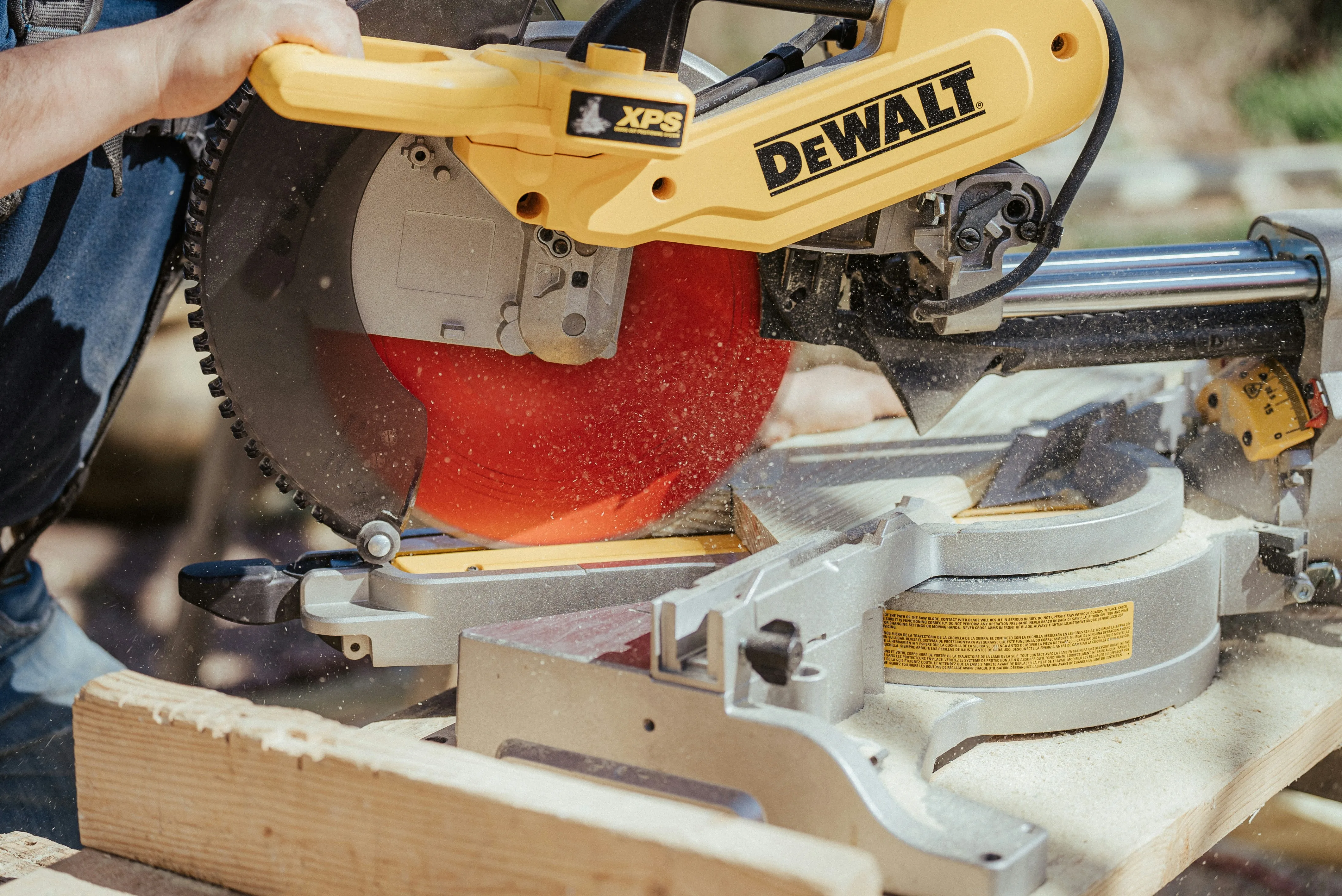Professional contractor using miter saw on construction project